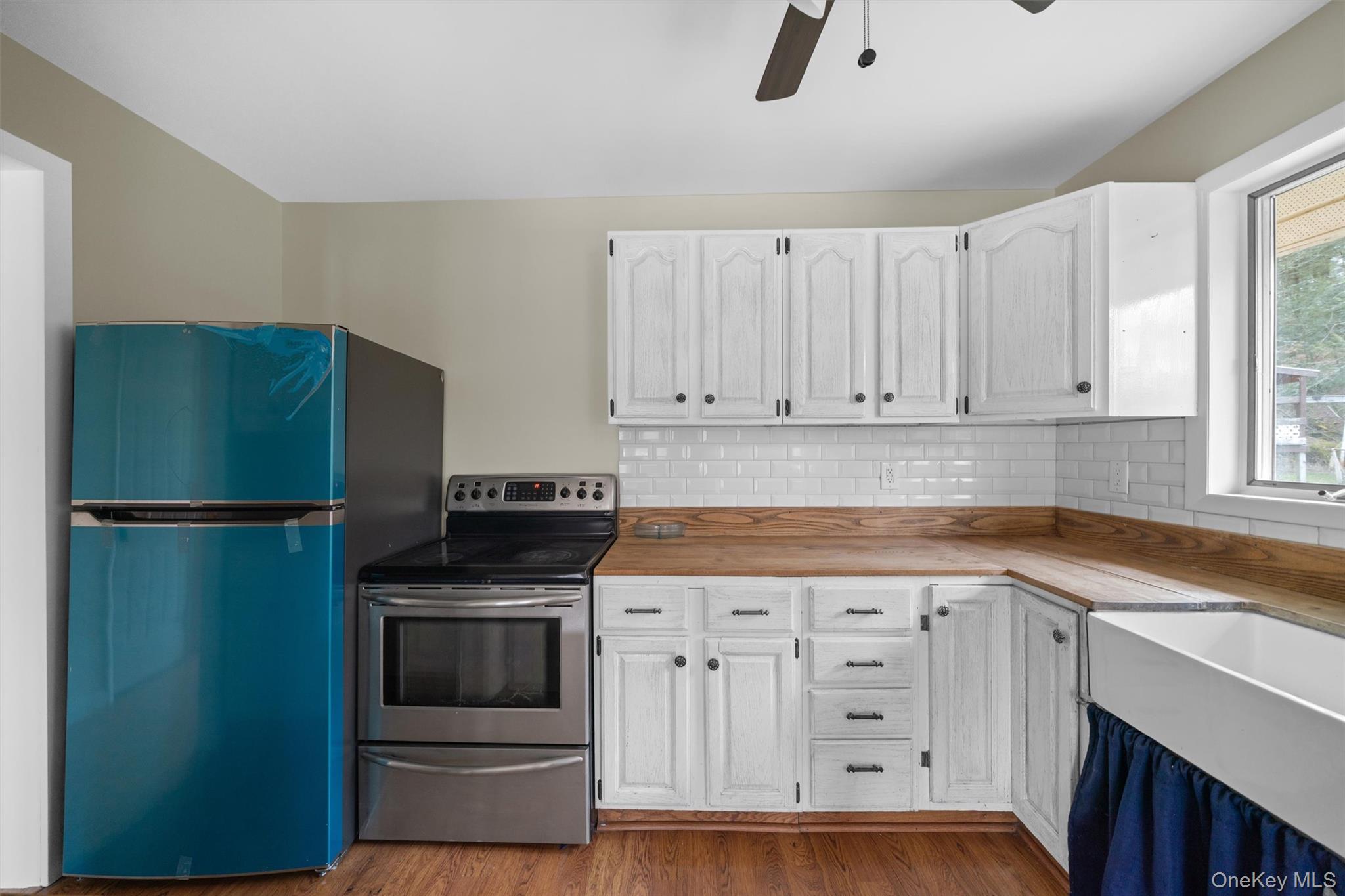242 Callicoon Center Road Jeffersonville, NY 12748 - Photo 20 of 44 a kitchen with white cabinets and stainless steel appliances
