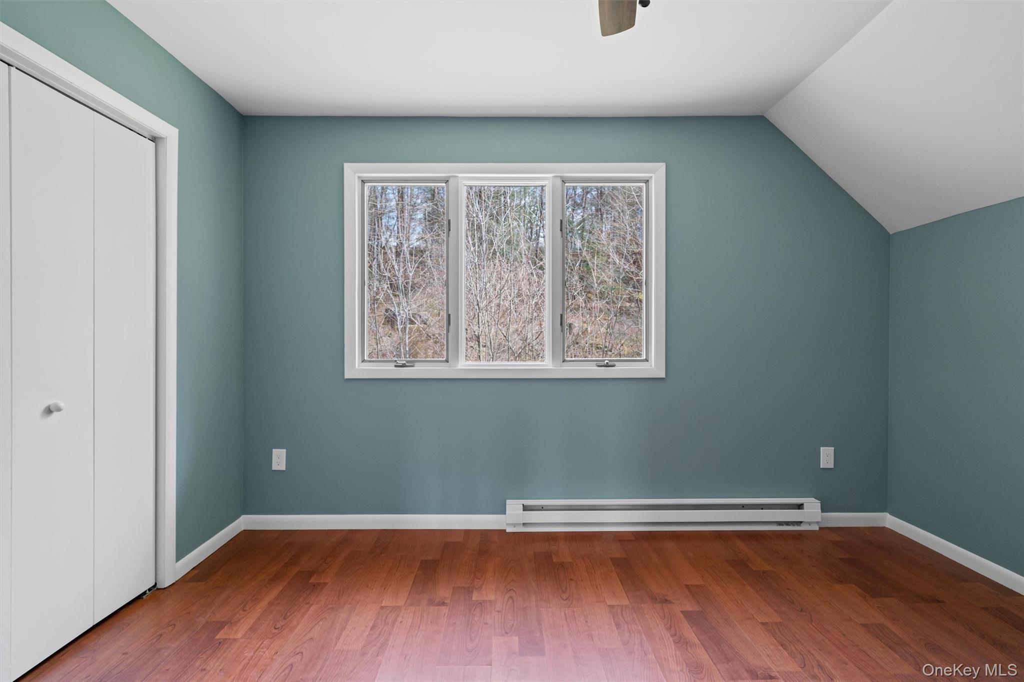242 Callicoon Center Road Jeffersonville, NY 12748 - Photo 27 of 44 an empty room with wooden floor and windows