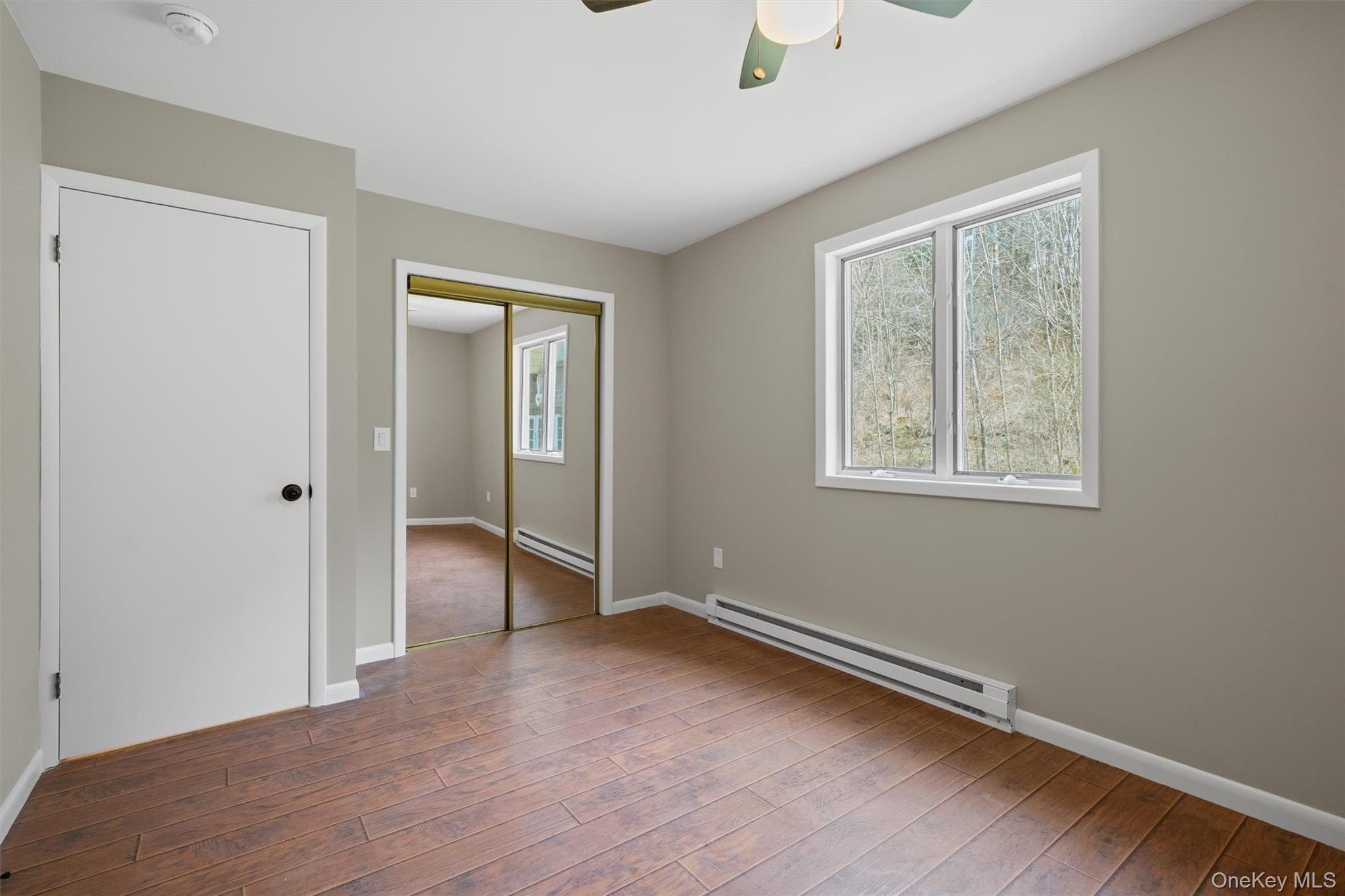 242 Callicoon Center Road Jeffersonville, NY 12748 - Photo 5 of 44 a view of an empty room with wooden floor and a window