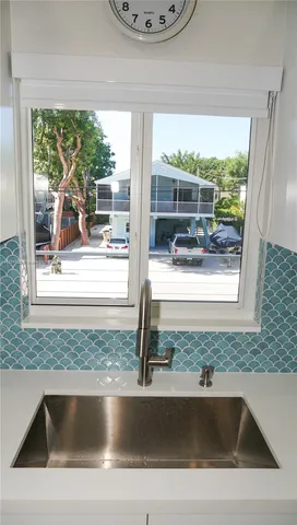 a kitchen with cabinets appliances a sink and a counter top space