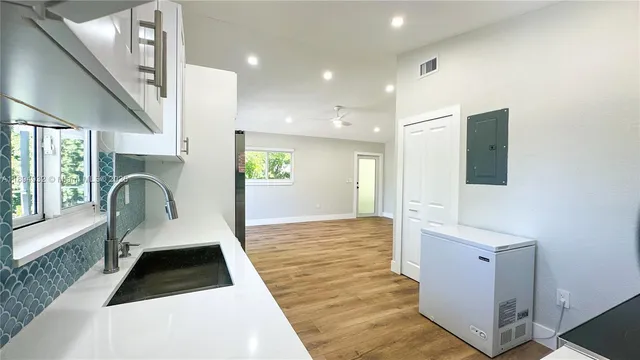 a kitchen with stainless steel appliances granite countertop a sink and a stove