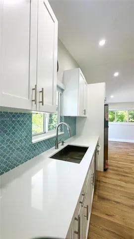 a view of small space with wooden floor and a window