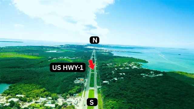 a backyard of a house with lots of green space table and chairs