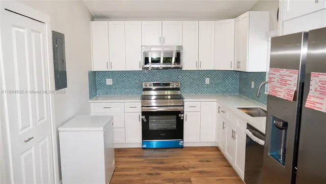 a kitchen with granite countertop a stove and a refrigerator
