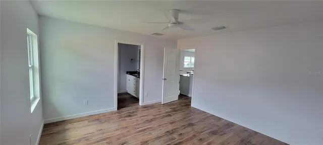a view of a hallway with wooden floor