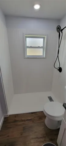 a bathroom with a shower and toilet