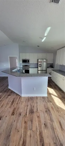 a view of kitchen with wooden floor