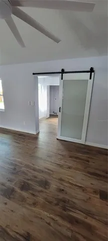 a view of empty room with wooden floor