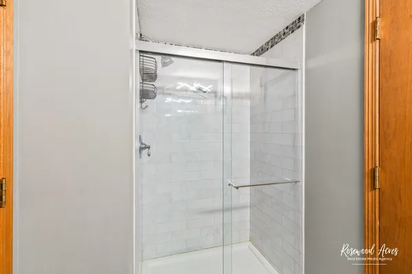 a bathroom with a glass shower door