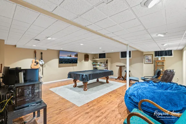 a living room with furniture a wooden floor and a flat screen tv