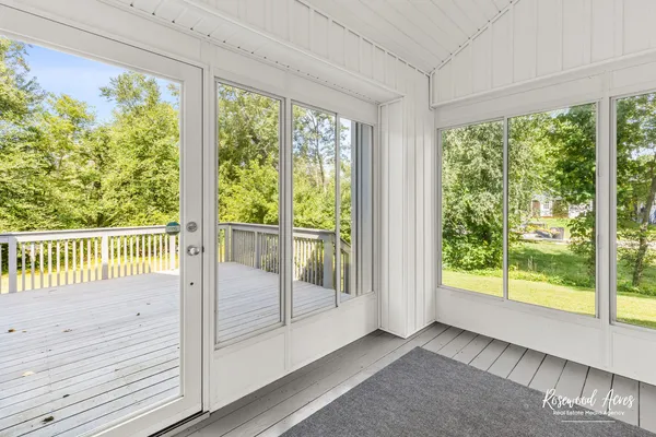 a view of a room with wooden floor and door