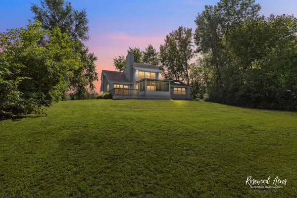 a view of a big room with a big yard and large trees