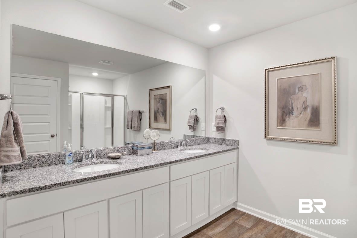 1235 Hayward Loop Foley, AL 36535 - Photo 20 of 26 Bathroom featuring vanity, wood-type flooring, and a shower with shower door