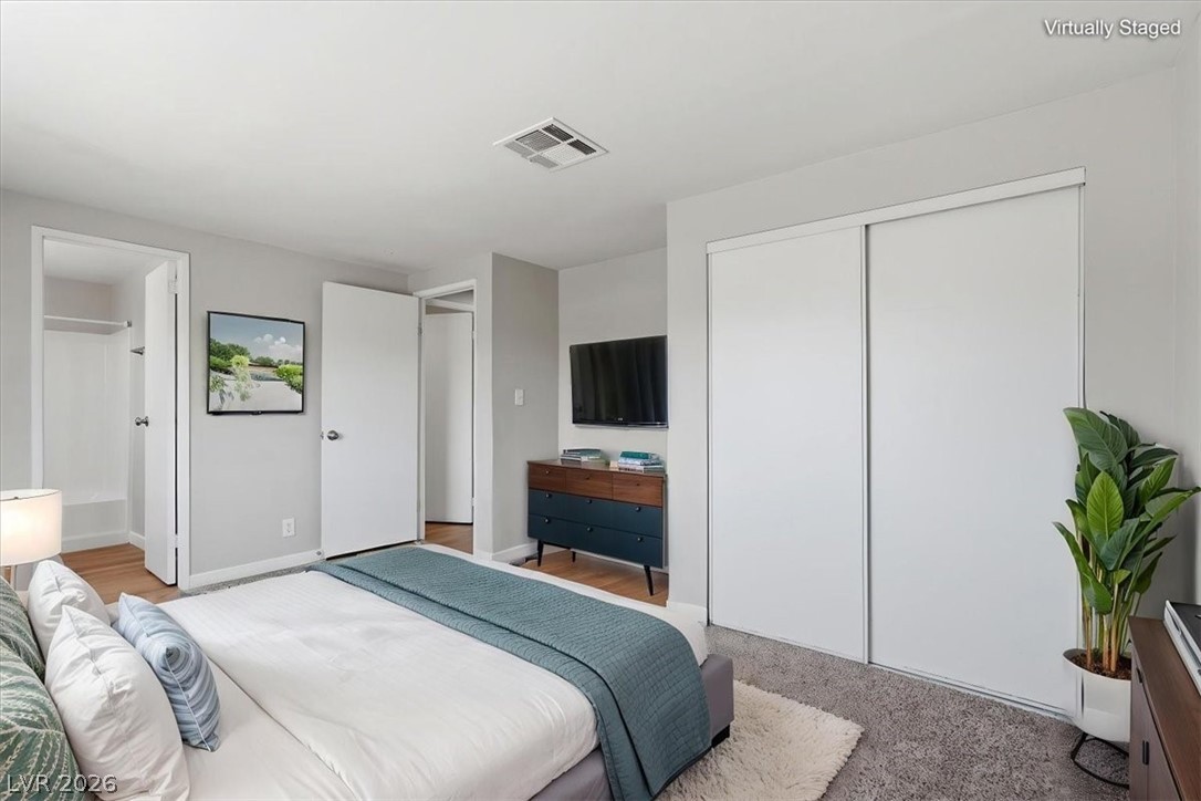 283 Aztec Lane Henderson, NV 89015 - Photo 17 of 21 Well-lit bedroom featuring two large sliding door closets for ample storage.