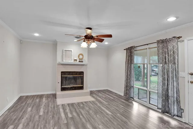 a view of an empty room with a fireplace and a window