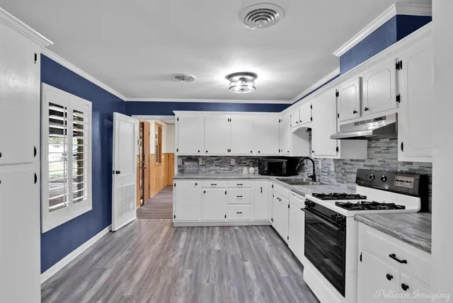 a kitchen with a white cabinets and appliances