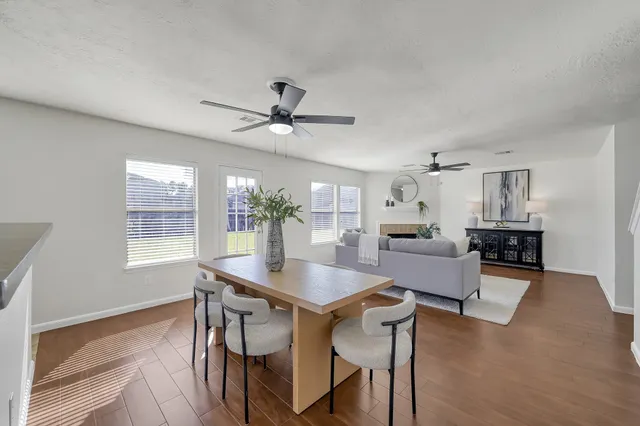 a dining room with furniture and window
