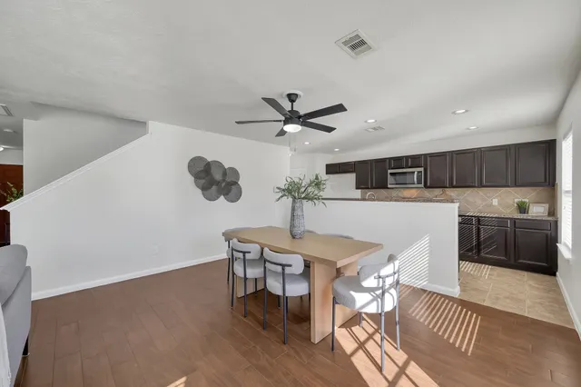 a view of a dining room with furniture and wooden floor
