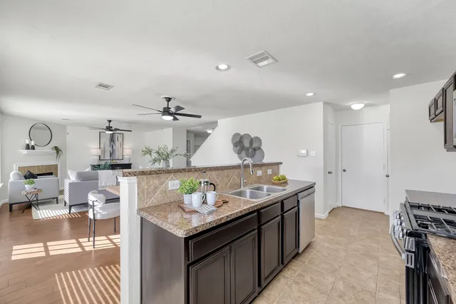 a kitchen with stainless steel appliances granite countertop a sink and cabinets