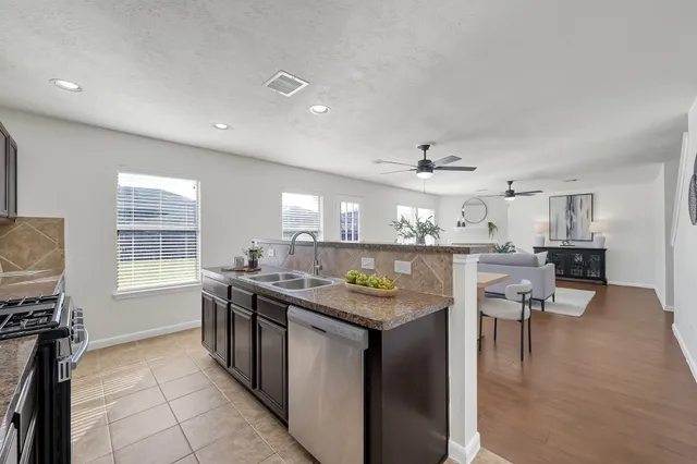 a kitchen with stainless steel appliances granite countertop a sink and cabinets