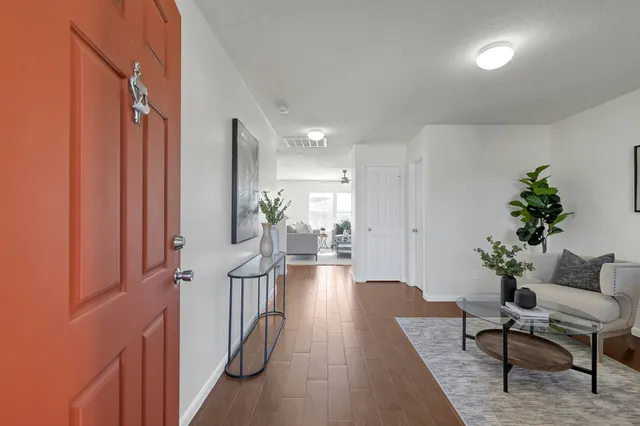 a living room with furniture and a potted plant
