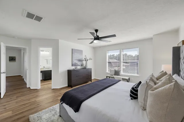 a bedroom with a bed and wooden floor
