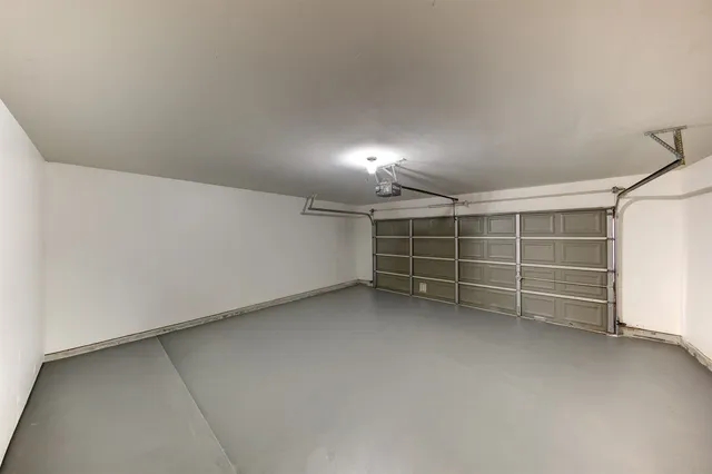 a view of room with walk in closet with empty racks