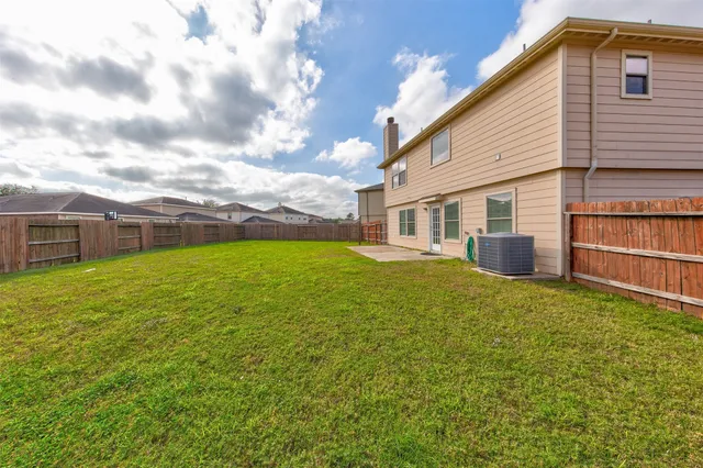 a view of a house with a backyard