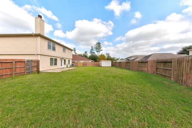 a view of a house with a backyard