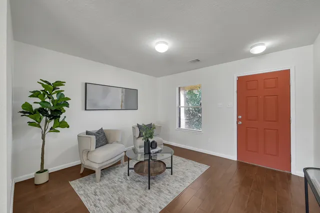 a living room with furniture and a potted plant