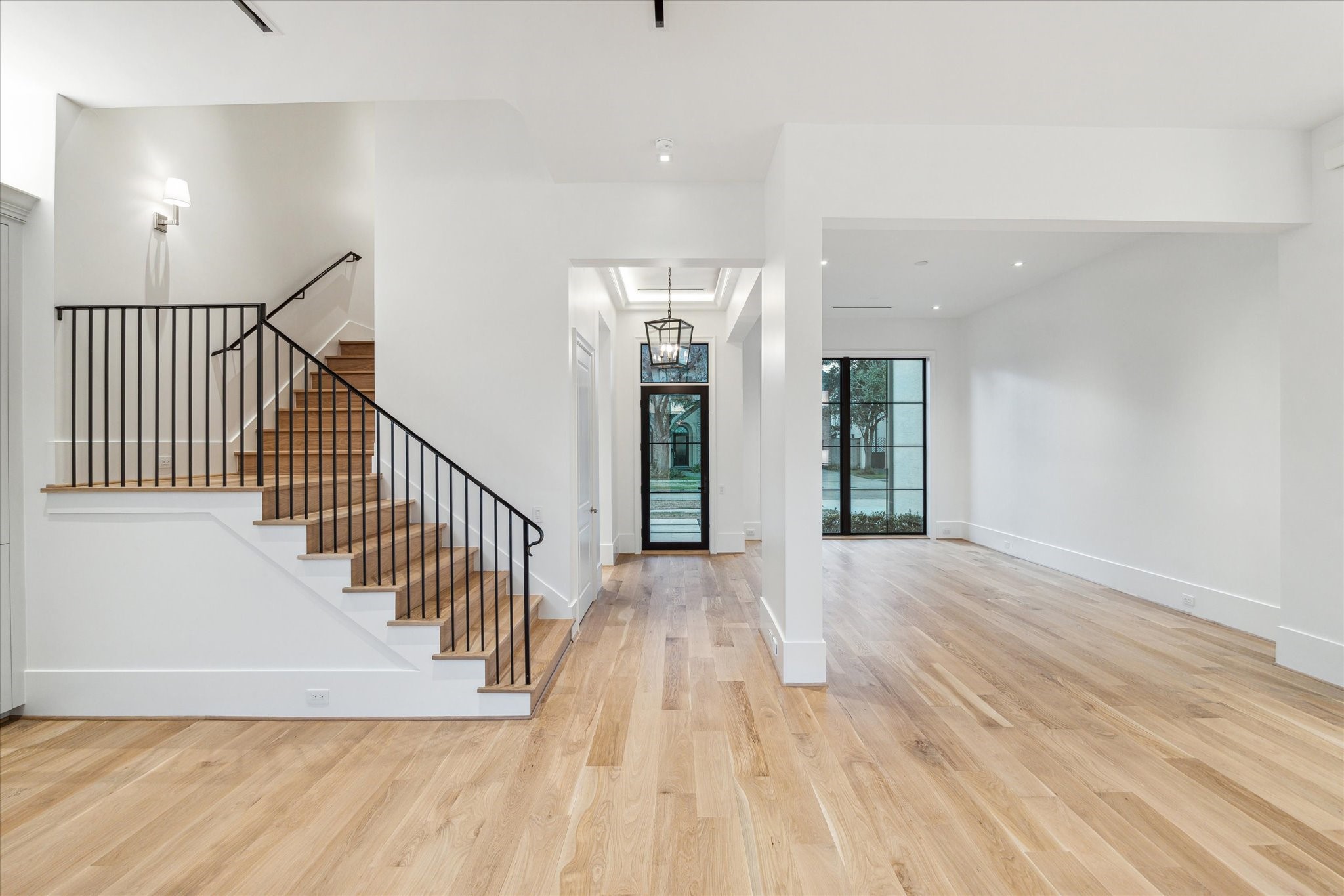 2711 Eastgrove Lane Houston, TX 77027 - Photo 11 of 48 a view of a hallway with wooden floor and windows