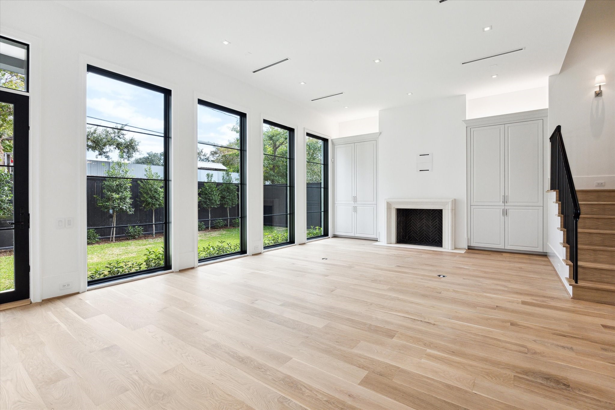 2711 Eastgrove Lane Houston, TX 77027 - Photo 12 of 48 a view of an empty room with wooden floor and a window