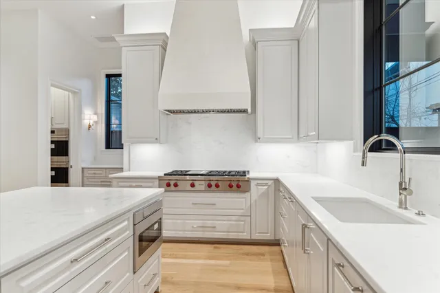 a kitchen with a sink stove and cabinets