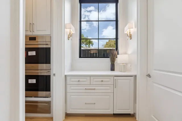a view of cabinets and window with wooden floor