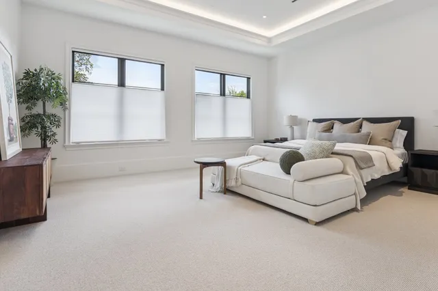 a spacious bedroom with a bed and a window