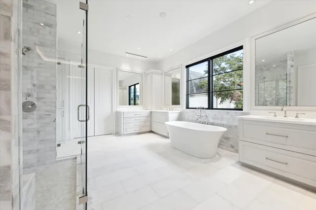 a bathroom with a tub sink toilet and mirror