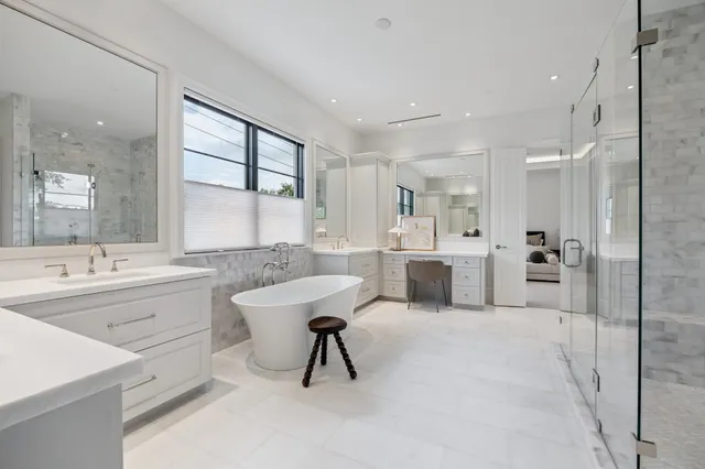 a large white kitchen with a sink and cabinets