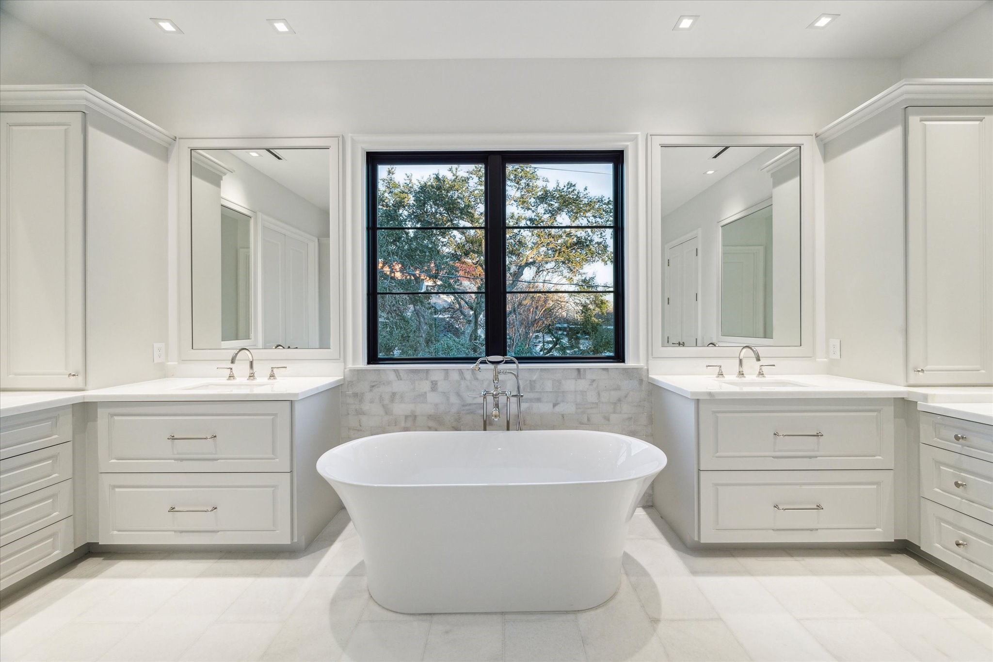 2711 Eastgrove Lane Houston, TX 77027 - Photo 31 of 48 a bathroom with a sink double vanity mirror and a bathtub
