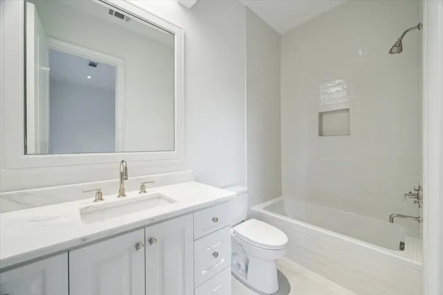 a bathroom with a sink a toilet tub and shower