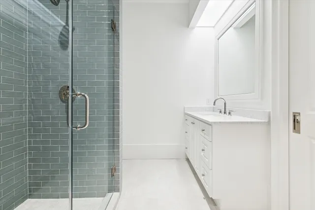 a bathroom with a double vanity sink and mirror