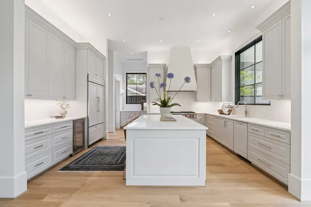 a kitchen with a sink stove and cabinets