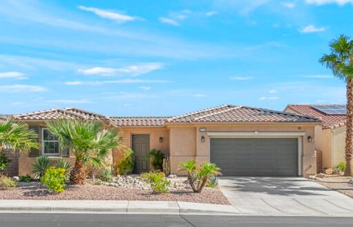1940 Fan Palm Way Palm Springs, CA 92262 - Photo 1 of 4 a front view of a house with a garden