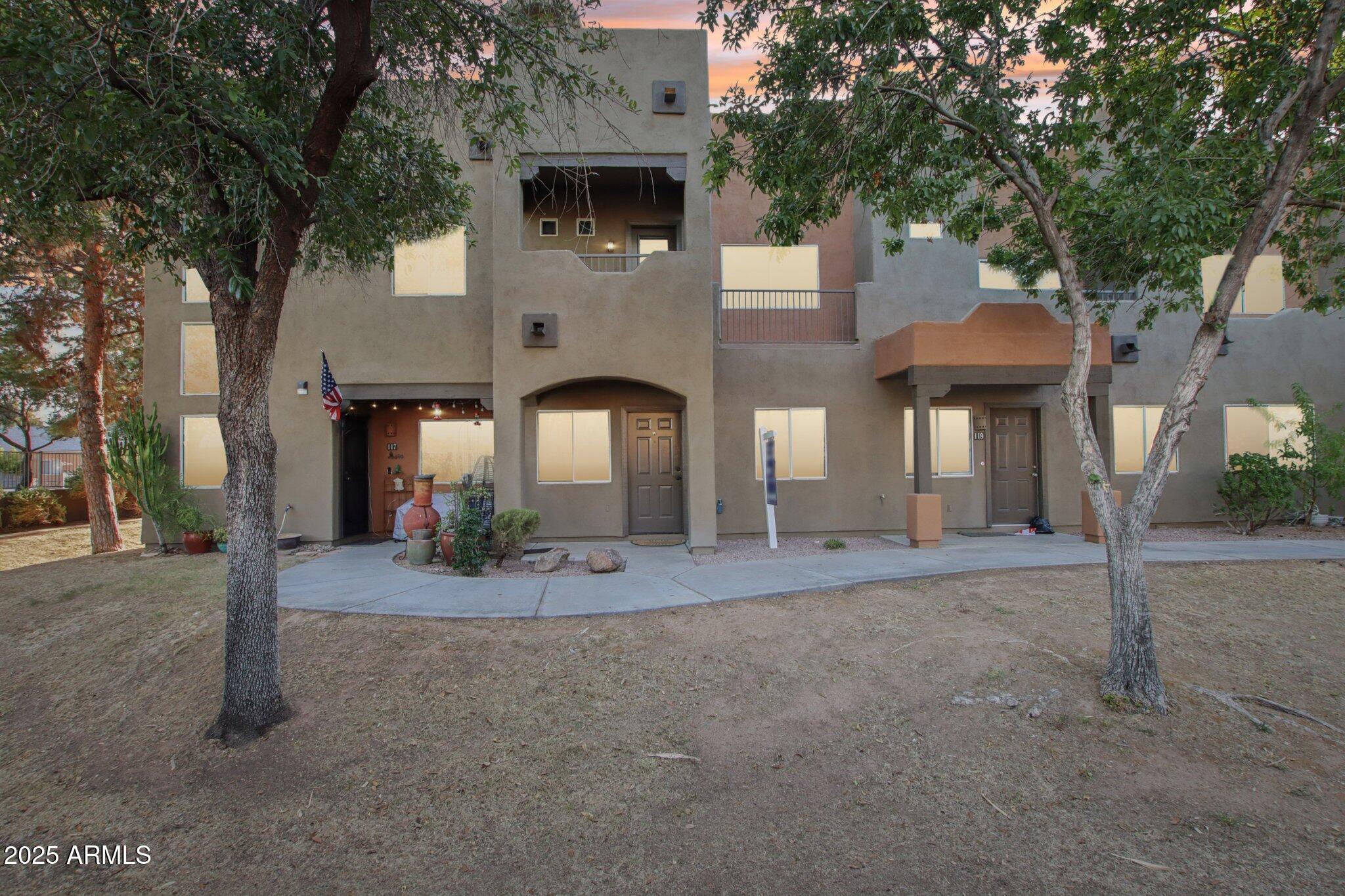 a view of a house with large tree and a large tree