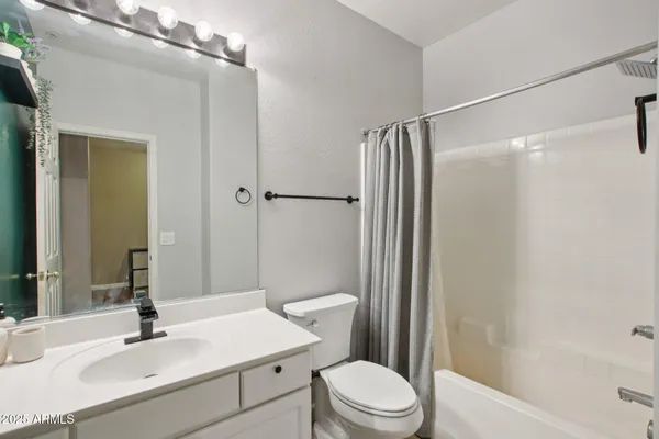 a bedroom with a bed and a ceiling fan