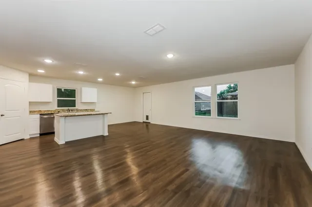 a view of kitchen with kitchen island and hard wood floor