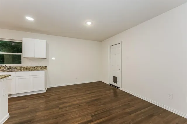 a kitchen with kitchen island white cabinets and stainless steel appliances