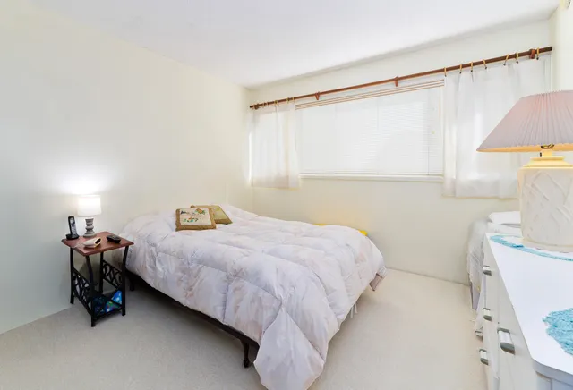 a bedroom with a bed and a table