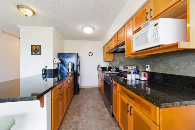 a kitchen with stainless steel appliances granite countertop a sink and cabinets