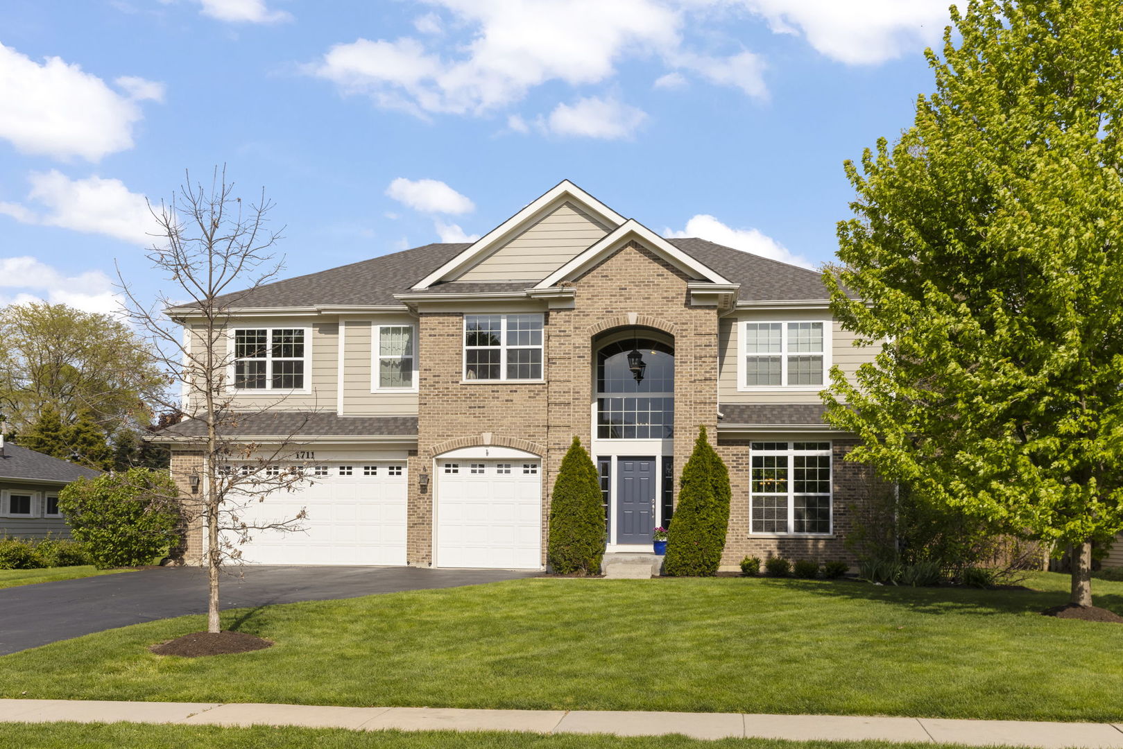 1711 Driving Park Road Wheaton, IL 60187 - Photo 1 of 41 a front view of a house with a yard