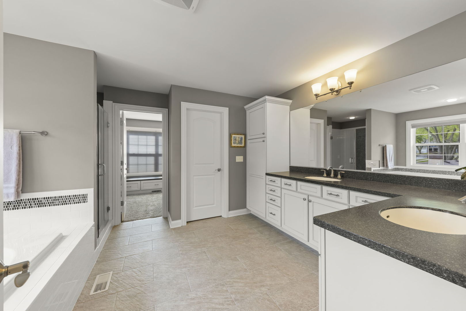 1711 Driving Park Road Wheaton, IL 60187 - Photo 16 of 41 a large bathroom with a granite countertop sink and a mirror